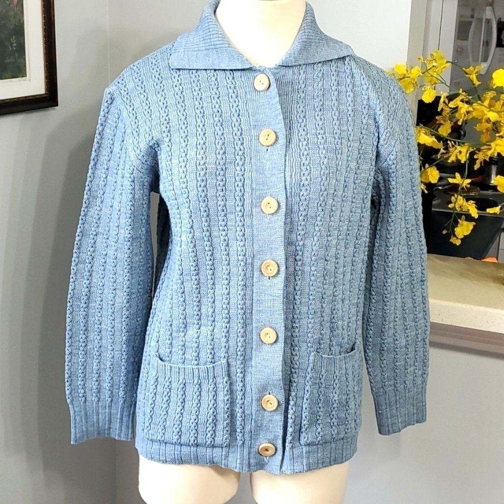 Beautiful hand Knit sweater. Size large. Blue with wooden buttons and 2 pockets.